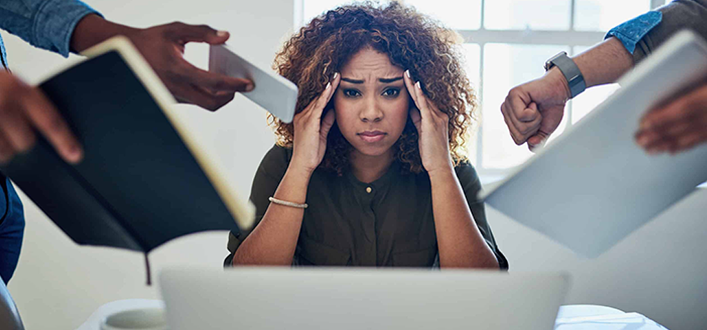 Shot of a stressed out young woman working in a demanding career