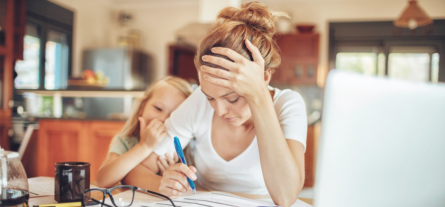 A woman with her child stressed over the impact of her debt with the high inflation and interest rates.